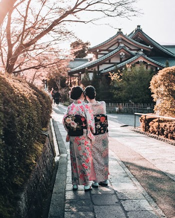 Two Women Standing Outdoors