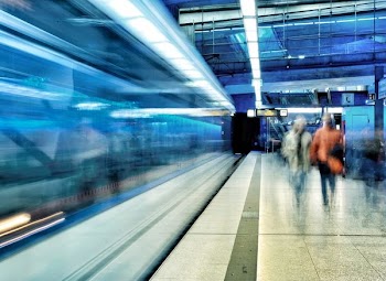two women walking in walkway inside building