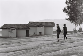 Two Women Walking Near House