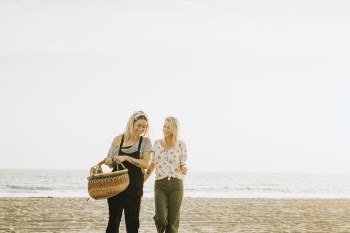 Two Women Walking on a Seashore