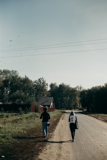 Two Women Walking on Road
