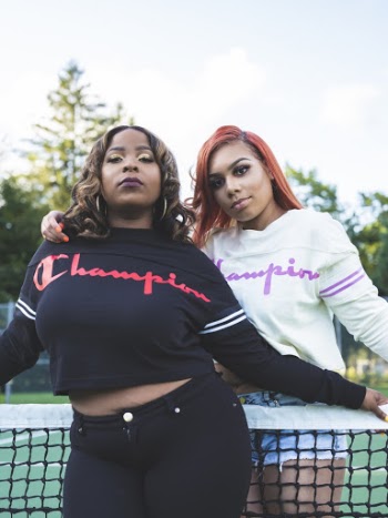 Two Women Wearing Black and White Champion Sweaters