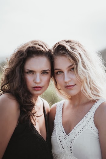 Two Women Wearing Black and White Tank Tops