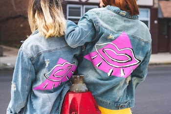 Two women wearing blue denim jackets