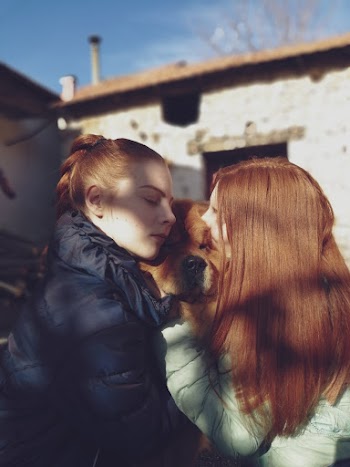 Two Women Wearing Bubble Jackets Facing Each Other