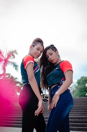 Two Women Wearing Pair Green-and-red Shirt