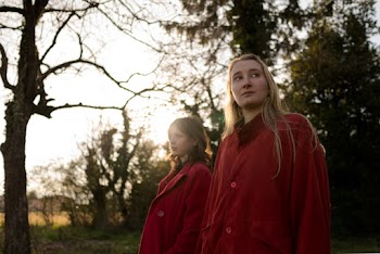 Two Women Wearing Red Coats