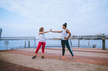 Two Women Wearing Sports Attire 
