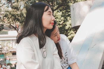 Two women wearing  white t-shirts