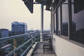 Two Wooden Chairs on Terrace of Building