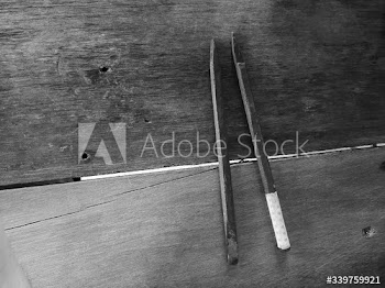 Two wooden sticks on a wooden table
