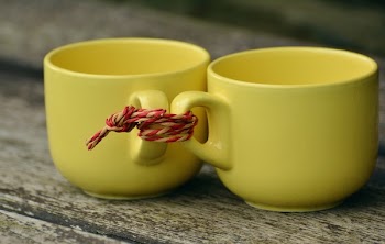 Two Yellow Mugs on Brown Wooden Surface
