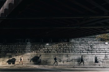 Under Busy City Bridge People Walking