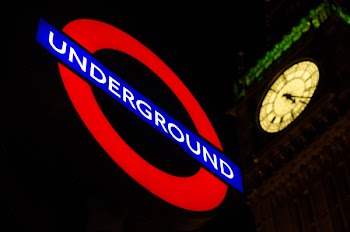 Underground Signage Near Clock Tower during Night