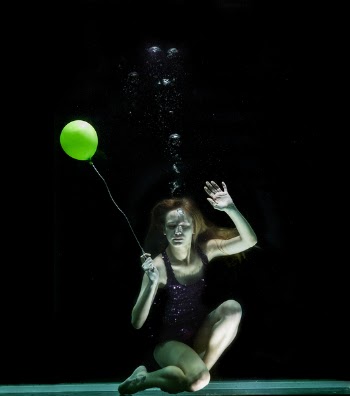 Underwater Photography of Woman Holding Green Balloon