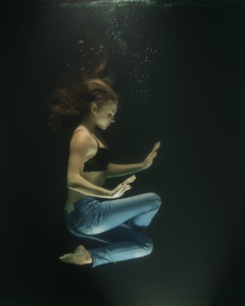 Underwater Photography of Woman Wearing Blue Jeans and Black Bra