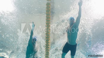 Underwater view male swimmers competing in swimming pool