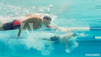 Underwater view male swimmers competing in swimming pool