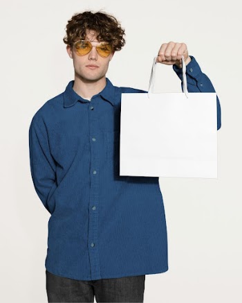 Unhappy man holding shopping bag | Free Photo - rawpixel