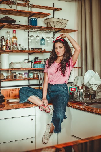 Unknown Actress Sitting on Brown Wooden Table