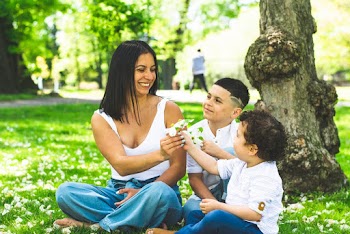 Unknown Celebrities Sitting on Green Grass Field