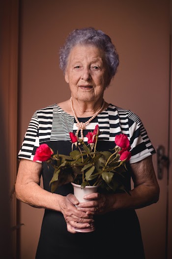 Unknown Celebrity Carrying Green-leafed Plant With Red Flowers