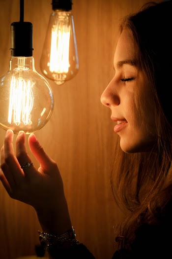 Unknown Celebrity Facing Incandescent Bulb