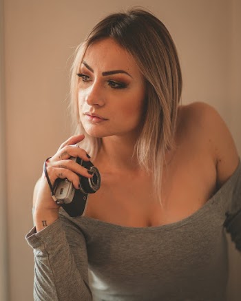 Unknown Celebrity Holding Black Camera Facing Sideways
