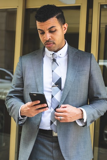 Unknown Celebrity Holding Smartphone Outdoors
