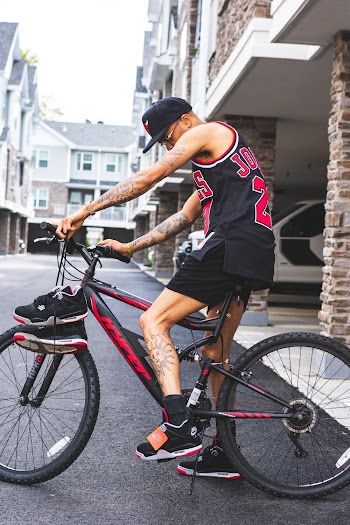 Unknown Celebrity Riding on Black and Red Suspension Bike