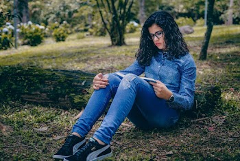 Unknown Celebrity Sitting in Green Grass