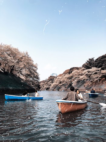 Unknown People Riding on Boats