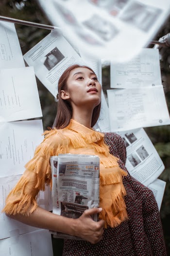 Unknown Person Carrying Newspaper