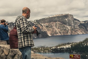 Unknown Person Holding Dslr Camera Standing Outdoors