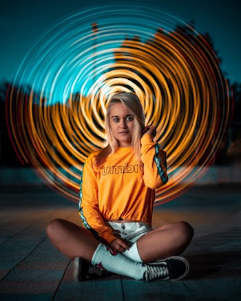 Unknown Person Sitting on Floor Outdoors