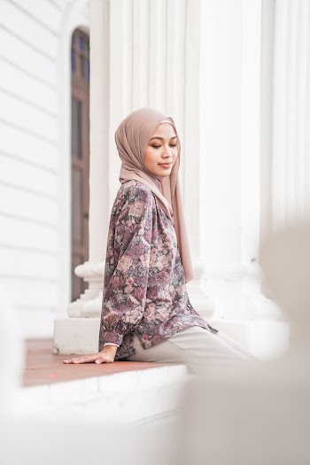 Unknown Person Sitting Outdoors