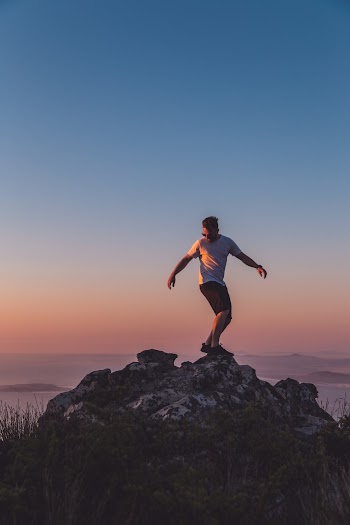 Unknown Person Standing on Rock Formation