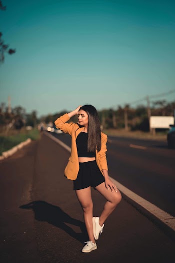 Unknown Woman Wearing Orange Topcoat and Black Crop Top