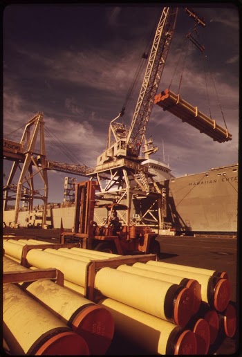Unloading pipes from ocean liner. | Free Photo - rawpixel