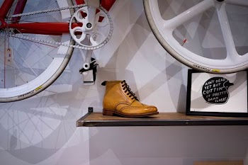 unpaired brown leather wingtip shoe on floating shelf