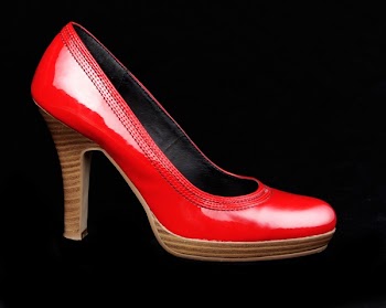 Unpaired Red Leather Platform Stacked Stilettos on Black Surface