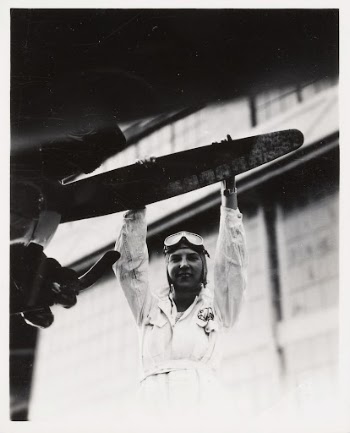 Untitled (Female Pilot Grabbing Propeller) | Free Photo - rawpixel