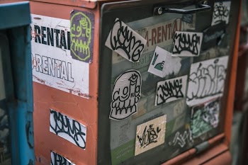 Urban Sticker Art On News Stand