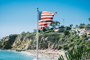 USA flag in front of a body of water