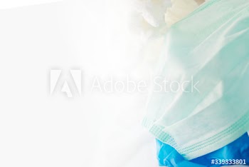 Used face masks in a contaminated waste bin