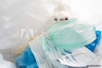 Used face masks in a contaminated waste bin