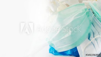 Used face masks in a contaminated waste bin