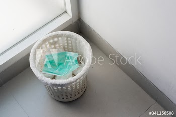 Used face masks in a contaminated waste bin