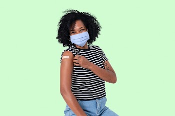 Vaccinated African woman presenting shoulder | Free stock photo | High Resolution image