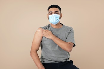 Vaccinated Indian man presenting shoulder | Free stock photo | High Resolution image
